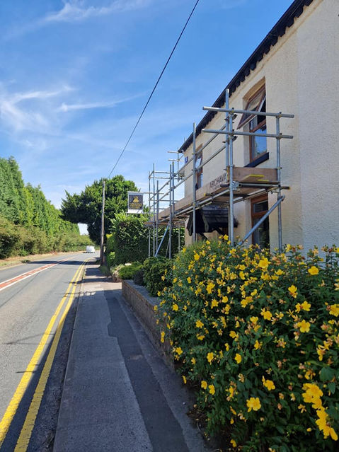 Scaffolding on sunny day next to a road