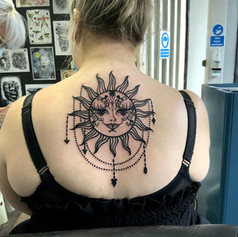 Sun tattoo on womans back