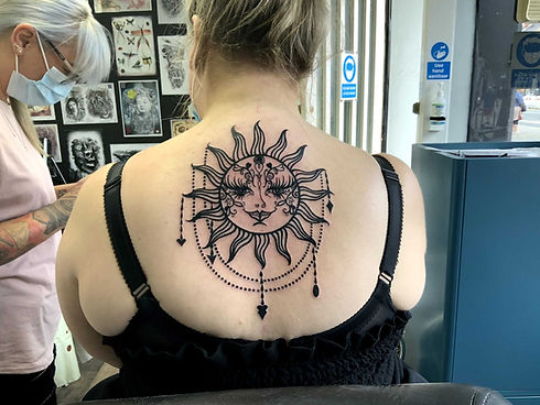 Sun tattoo on womans back