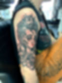 Tattoo of cartoon woman on persons right arm