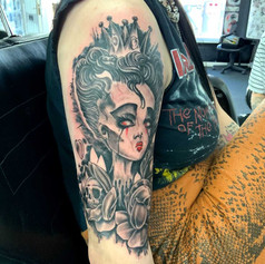 Tattoo of cartoon woman on persons right arm