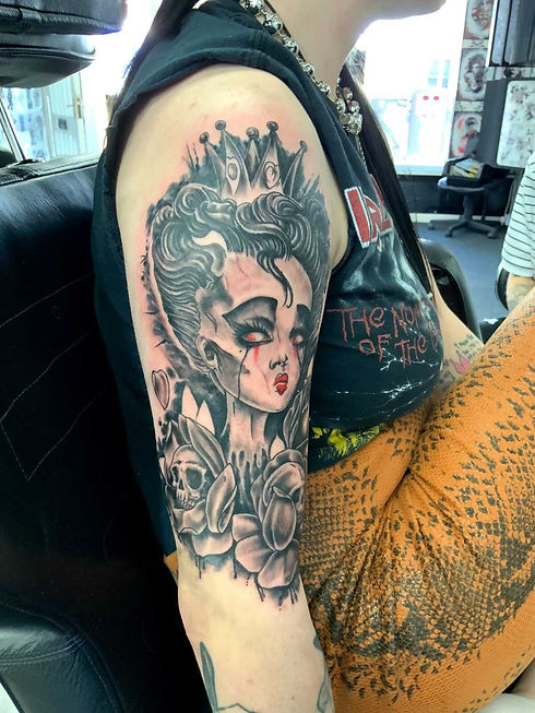 Tattoo of cartoon woman on persons right arm
