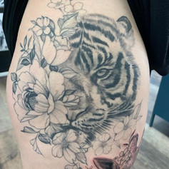 Tiger face and floral tattoo