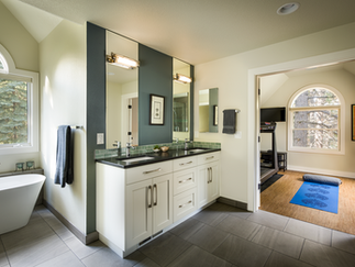 Owner's Suite Bathroom & Fitness Room after a remodel by PGC Building + Design
