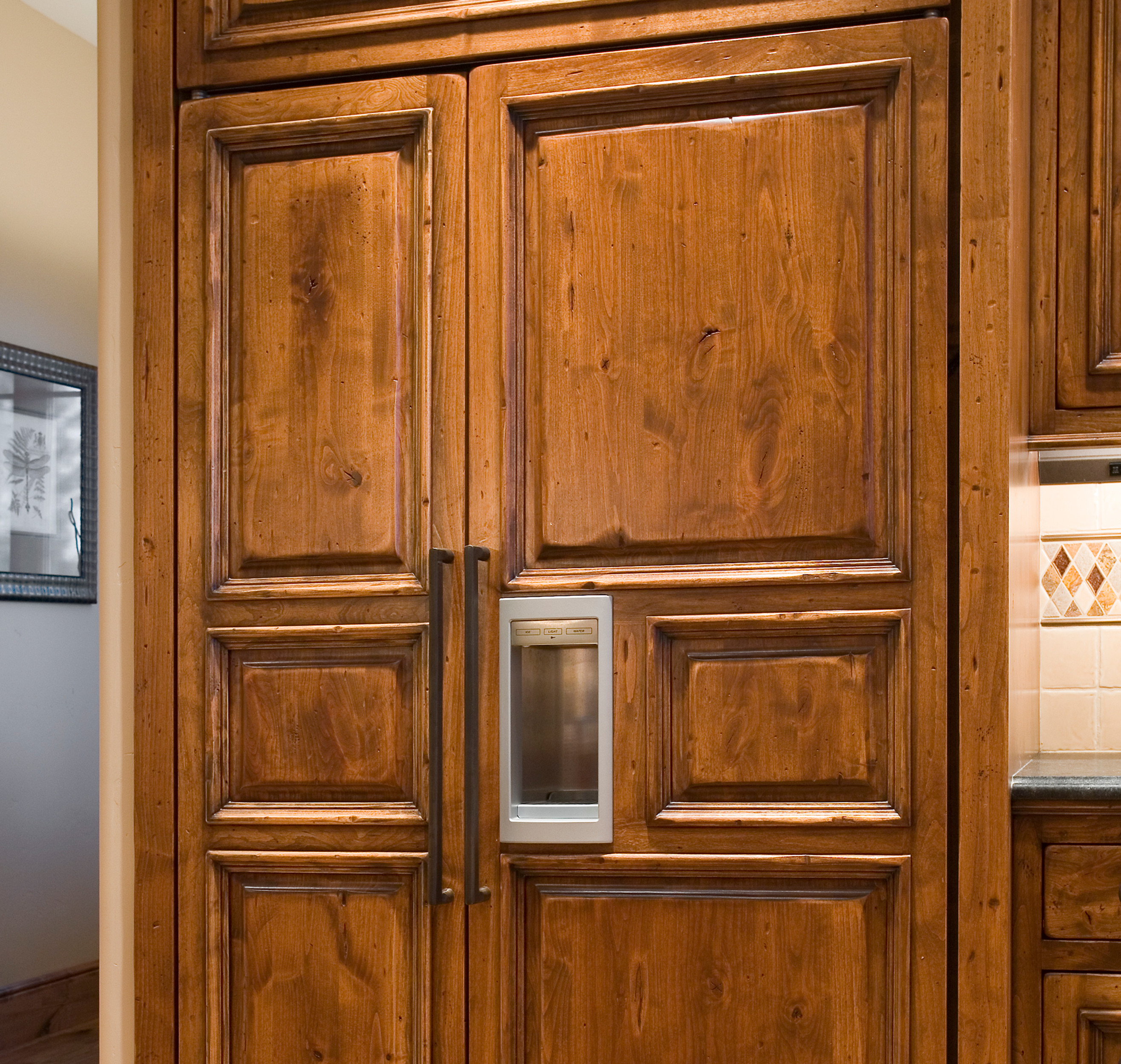 wood paneled refrigerator in a custom kitchen design by PGC Building + Design in Bend