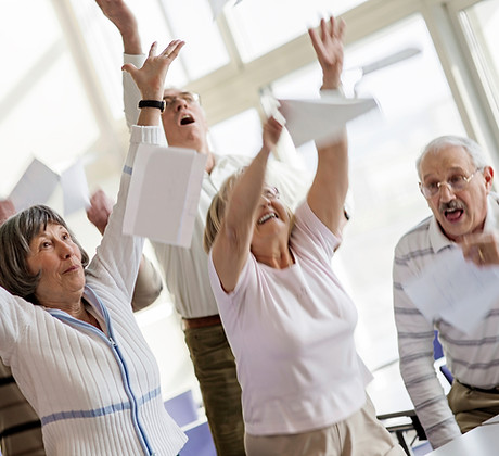 Happy seniors raising hands