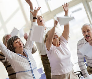 Happy seniors raising hands