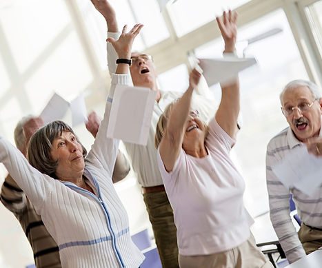 Happy seniors raising hands