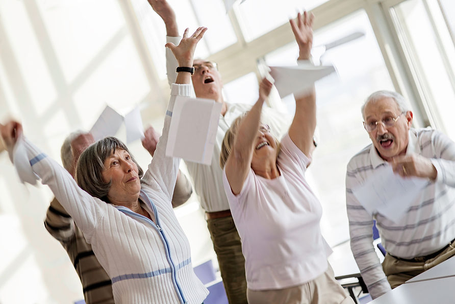 Happy seniors raising hands