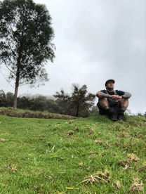 Man sitting under a tree in Maui.