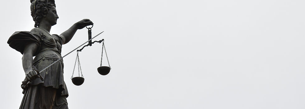 A statue of lady justice holding a scale