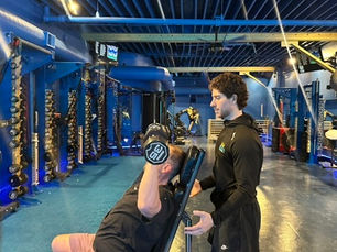 Coach guiding an adult through strength training after injury in East Lakeview Chicago