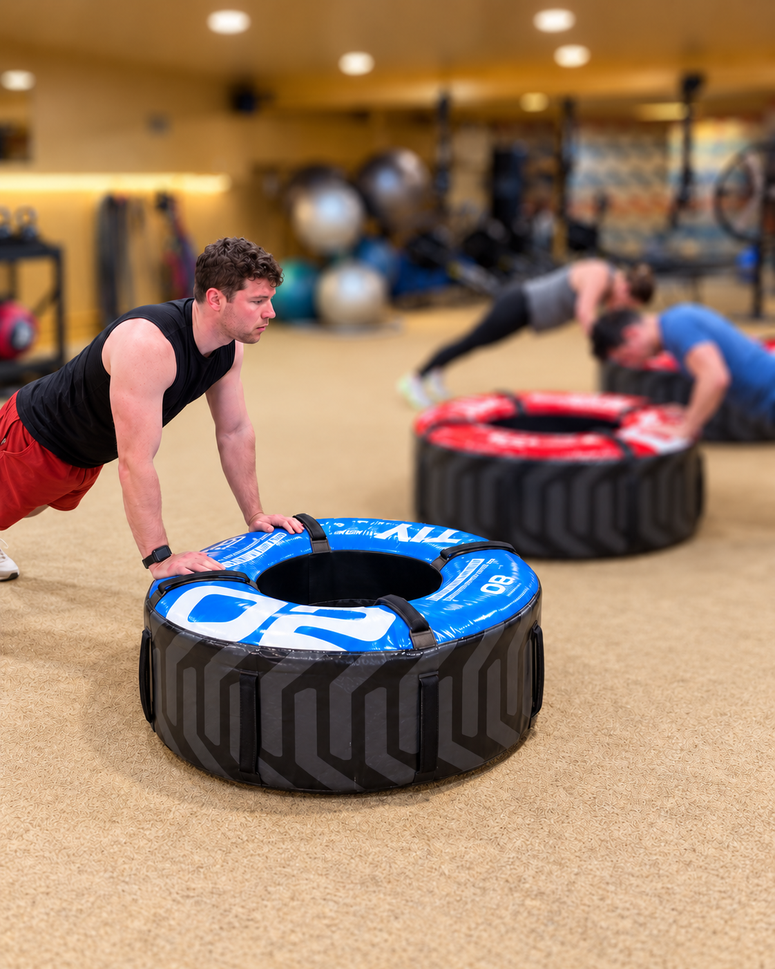 LEAP members performing tire push-ups during coached training in East Lakeview.