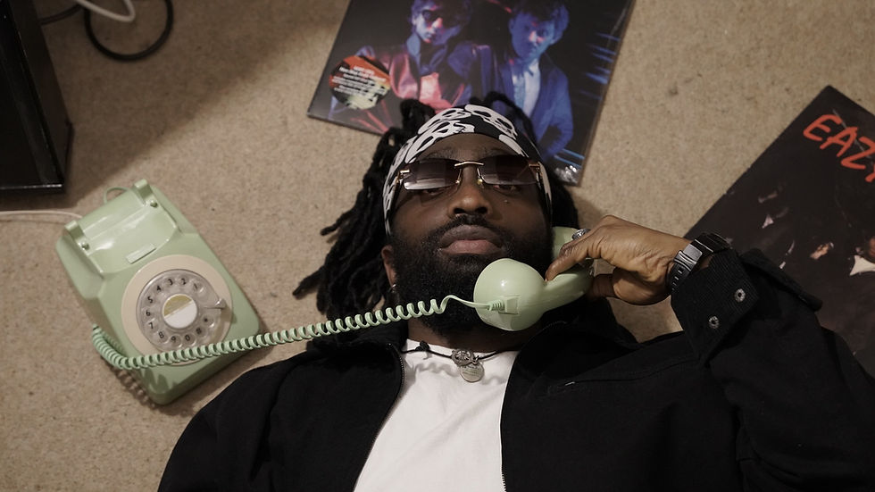 K. Flow laying on the floor holding a landline phone 