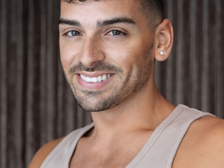 Headshot of instructor Joey against a gray curtain backdrop.