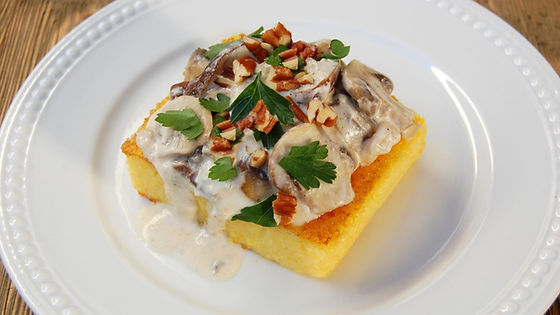 Pesto cream chicken on polenta cakes
