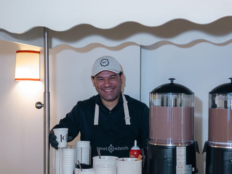 Branded hot chocolate cart with a uniformed server at a brand event in New York City