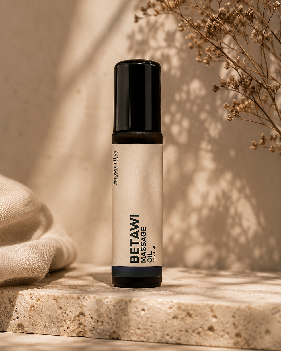 amber glass roller ball bottle in warm editorial setting betawi massage oil