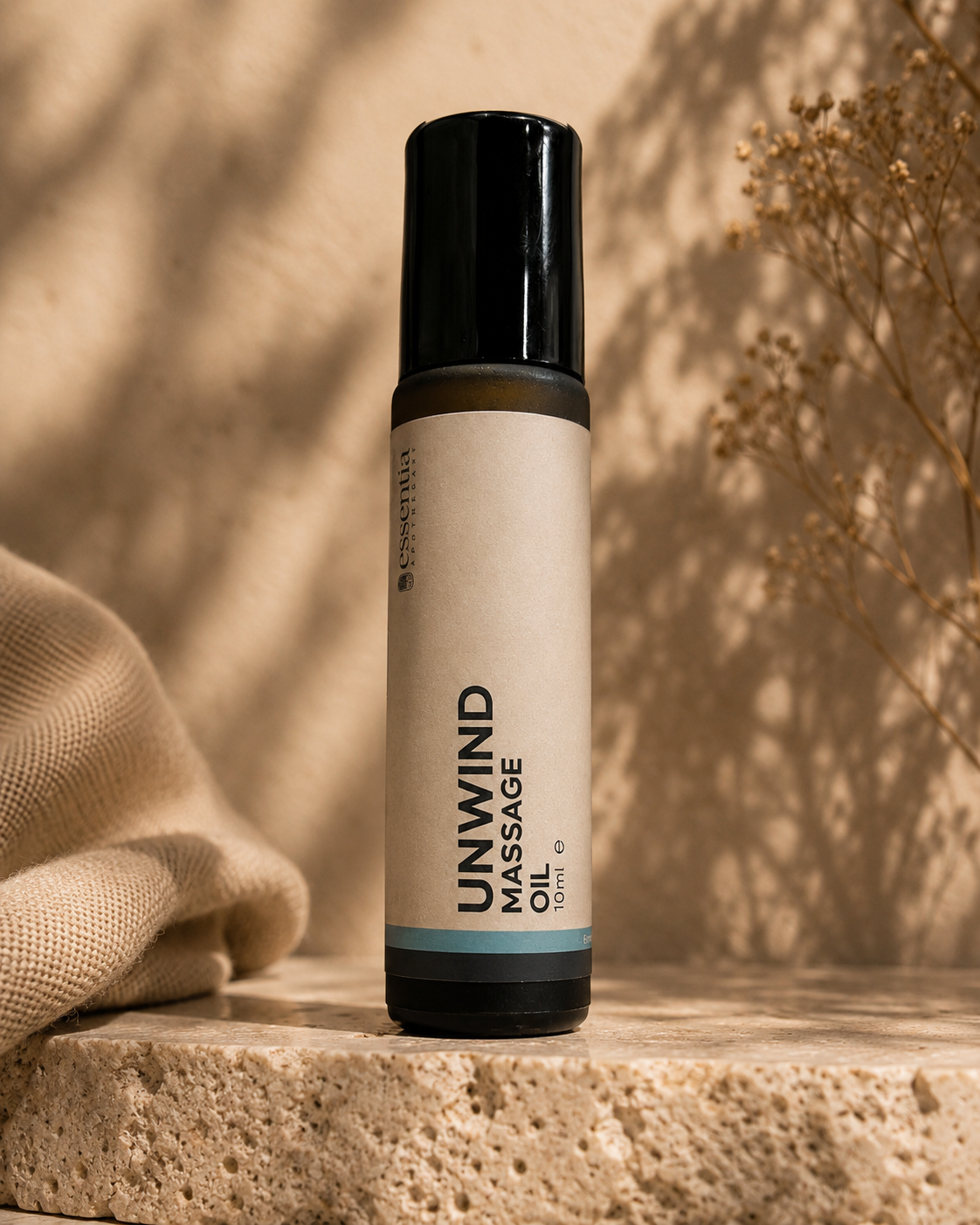 amber glass roller bottle in warm editorial setting unwind massage oil essentia apothecary