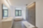 Bathtub in corian, Faucet and shower in tiled bathroom with windows towards garden.jpg
