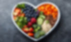 Heart-shaped bowl of healthy food with SNAP logo, symbolizing accessible nutrition and our community-first support.