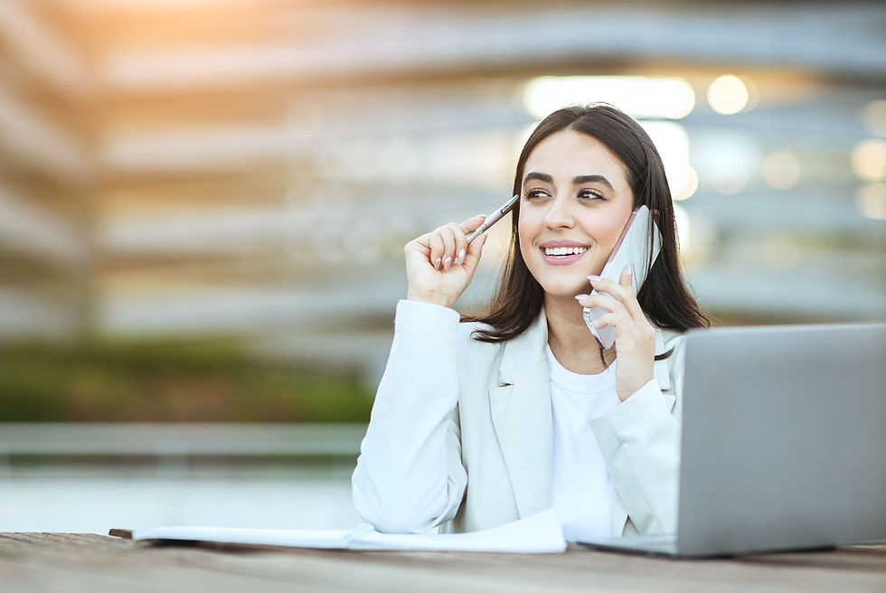 businesswoman-working-laptop-talking-cell-phone-outside.jpg