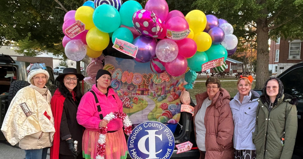 ICPHD Staff posing in front of their Candy Land Themed Halloween Display at Junk in the Trunk in Watseka IL. 
