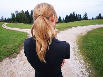 Woman look at two paths