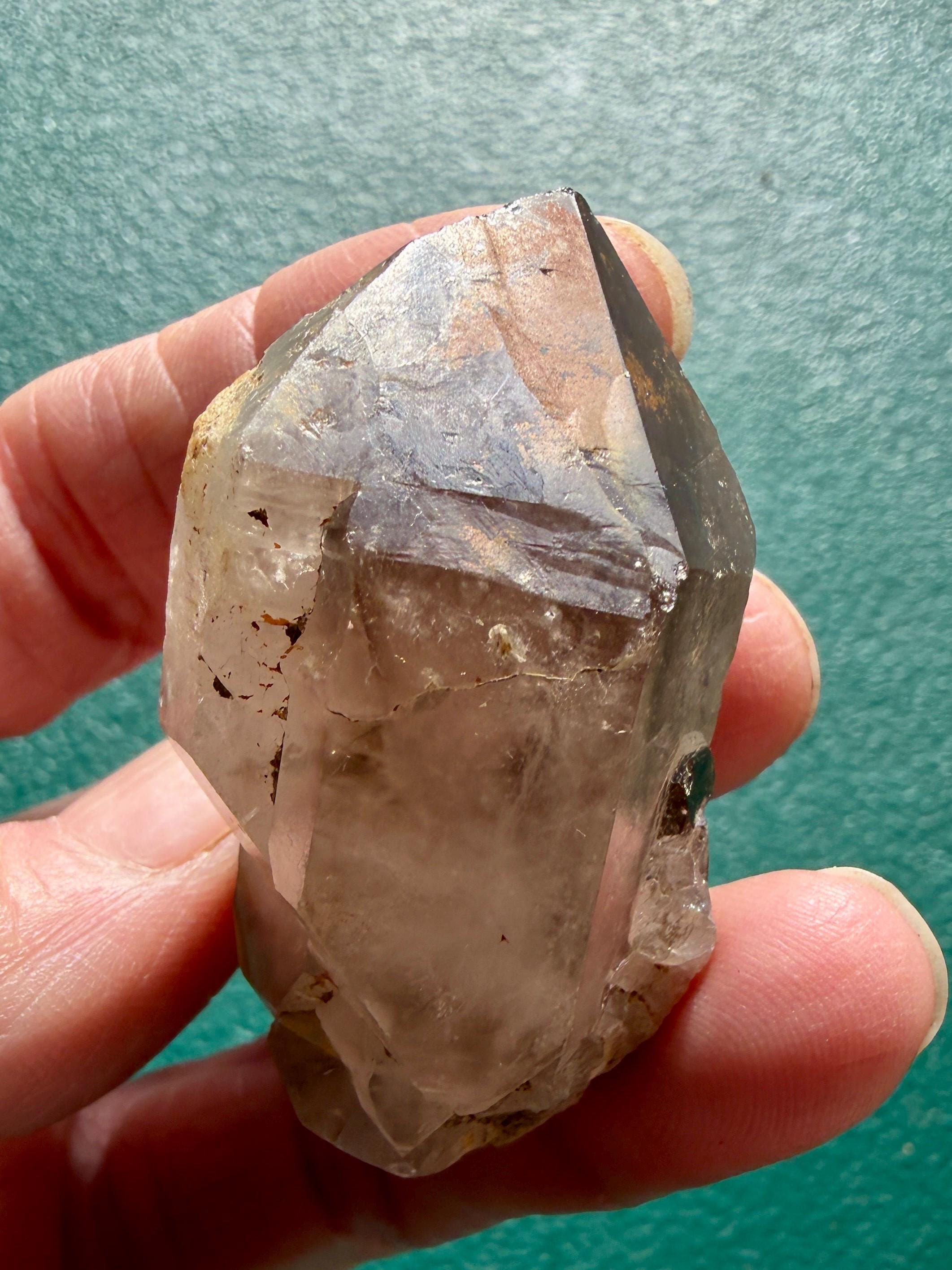 Raw natural phantom quartz with hematite point, rare record keeper