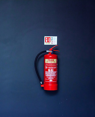 red fire extinguisher on gray wall_edite