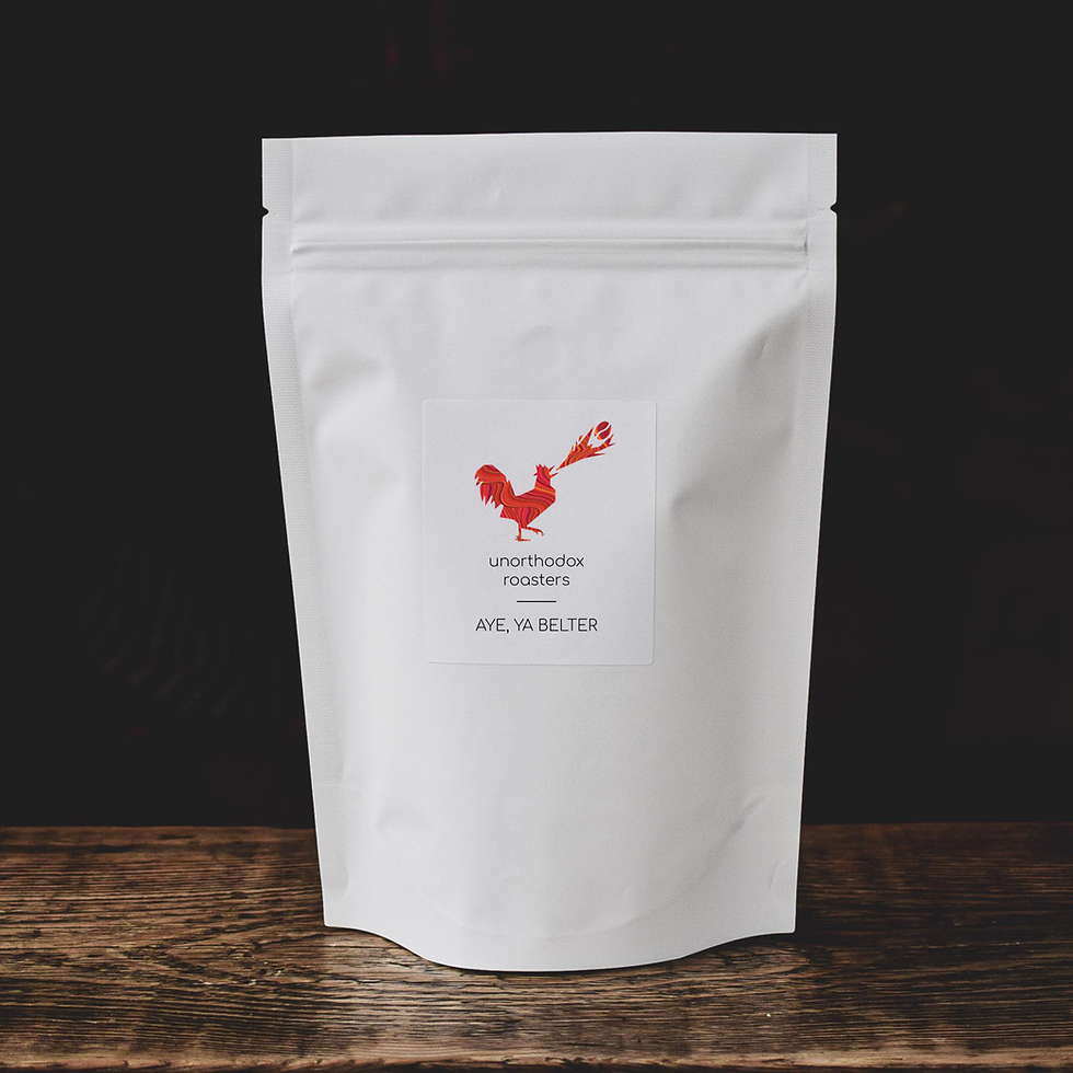 Thumbnail: Aye, Ye Belter - Unorthodox Roasters Coffee Bean Bag Product Image On Wooden Table - Typica, Caturra, Pache, Washed, Cajamarc