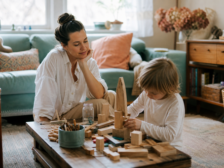 Parent observing a child’s self-directed homeschool project during deschooling