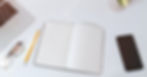 White work table with notes, smartphone and laptop_edited_edited_edited.jpg
