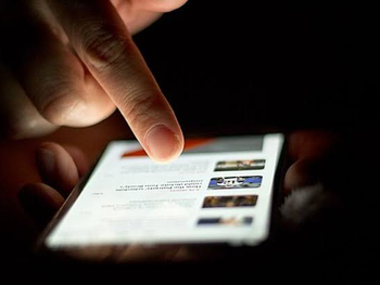 Scrolling through news on a smartphone