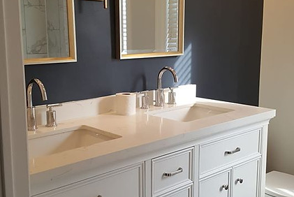 Navy Blue Benjamin Moore Accent Wall with White Vanity and Chrome Hardware in Bathroom by Good Choice Contracting