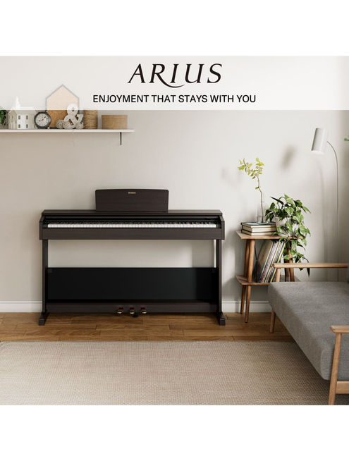 Yamaha digital piano in a living room setting.