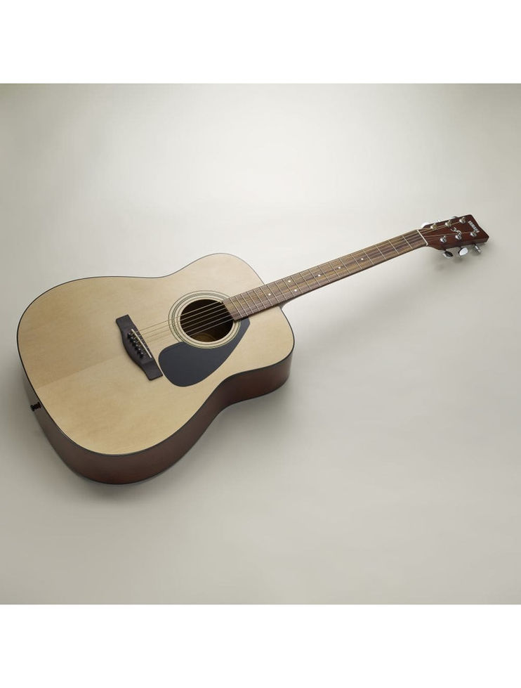 Side view of a Yamaha acoustic guitar lying flat.