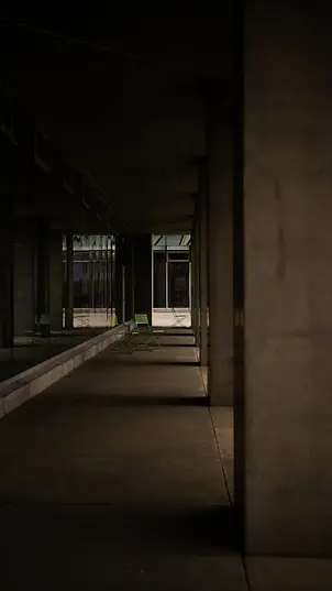 An outdoor hallway on the outside of an office building.