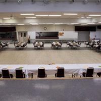 An elegantly arranged dinner setup in the large room of Westlock Memorial Hall. 