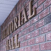 Exterior view of Westlock Memorial Hall showcasing its impressive signage. The sign, prominently displayed above the entrance, features bold, elegant lettering that reads 'Westlock Memorial Hall.' 