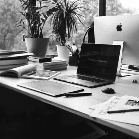Computer on a desk in black and white