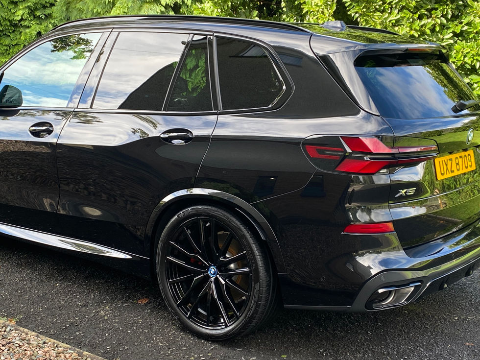Black luxury SUV, X5 50i, UK22 ETO, BMW X5 parked on driveway.