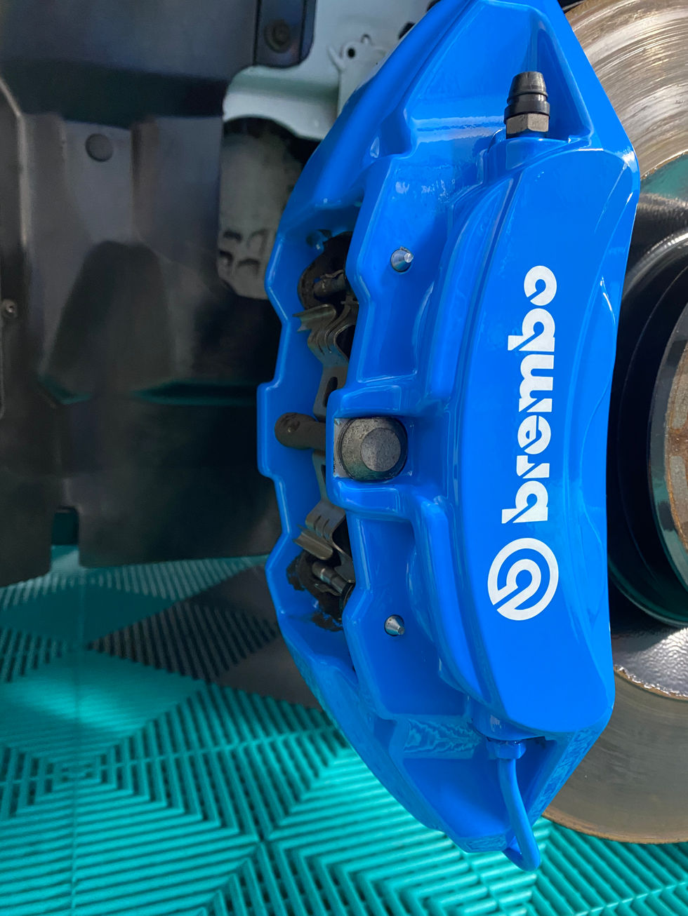Blue Brembo brake caliper with visible logo attached to disk brake.