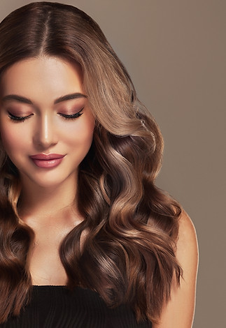 Beautiful laughing brunette model  girl  with long curly  hair . Smiling  woman hairstyle 