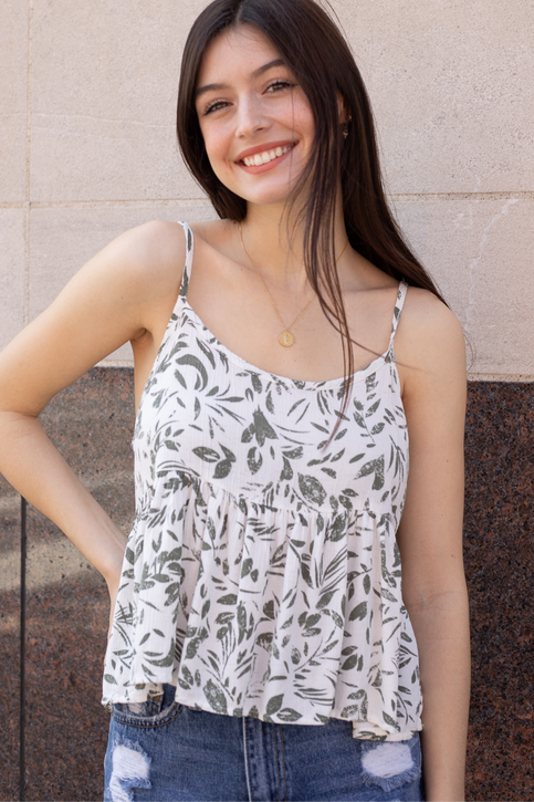 Model wearing baby doll style printed tank top with destroyed denim shorts