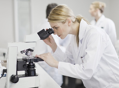 Scientist using microscope
