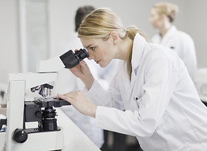 Female Scientist Using Microscope