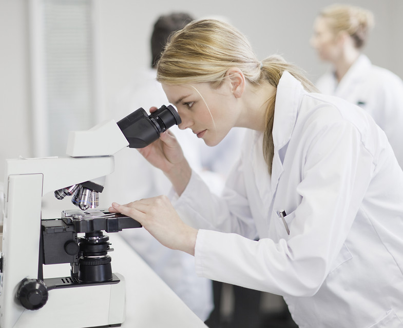 Scientist using microscope