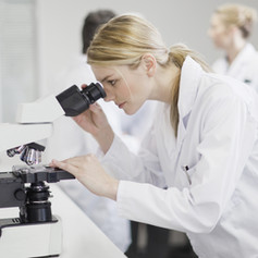 Female Scientist Using Microscope