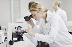 Scientist using microscope